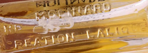 MOLINARD H.P CREATION LALIQUE molded signature on the underside of a modern Molinard De Molinard Eau De Toilette or Perfume Bottle. The bottle was made by Henri Pochete - H.P.