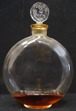 Close Copy Of Je Reviens-5 Perfume Bottle For Worth With An All-Glass Sliver Moon and Stars Stopper being decorated on both sidex and Molded WORTH To The Front Face. The Bottle is unsigned with no markings on the underside. Made by an unknown glassmaker for Worth.