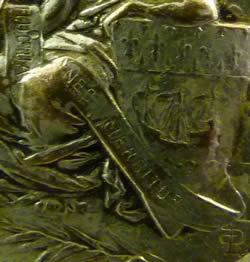Close-Up of Signature And Phrase On Louis Armand Rault Button Showing The Queen of Paris, Notre Dame and the Eiffel Tower and the Words Fluctuât Nec Mergitur (The Motto of The City of Paris Which Is Latin for Tossed But Not Sunk), and with LR Signature - RL Signature